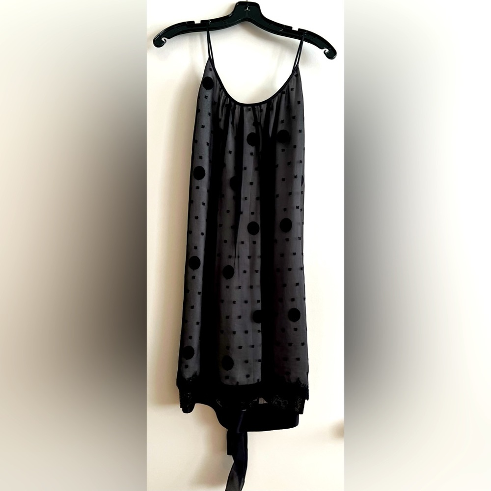 Black knee length dress, sleeveless with sequin detail at bottom